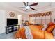 Bedroom boasting modern comforts like tray ceilings, ceiling fan, with a mounted TV, and workspace at 988 Treymont Way, Lawrenceville, GA 30045