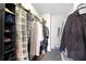 Organized walk-in closet with shelving and hanging space, maximizing storage and easy access to clothing at 988 Treymont Way, Lawrenceville, GA 30045