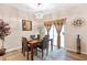 Well-lit dining room with a wooden table, modern chandelier, and a sliding door to outdoor area at 988 Treymont Way, Lawrenceville, GA 30045