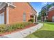 Exterior side view of a brick home featuring a walkway with garden lights and landscaping at 988 Treymont Way, Lawrenceville, GA 30045