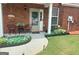 Inviting front porch with chairs, flowers, plants and brick facade at 988 Treymont Way, Lawrenceville, GA 30045