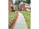 Manicured front yard with green grass, sidewalk and planting bed at 988 Treymont Way, Lawrenceville, GA 30045