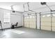 Spacious two-car garage with painted floor and bright overhead lighting, suitable for storage or home gym at 988 Treymont Way, Lawrenceville, GA 30045