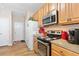 Well-equipped kitchen with stainless steel appliances, wood cabinetry, and hardwood style flooring at 988 Treymont Way, Lawrenceville, GA 30045