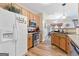 Kitchen featuring stainless steel appliances, wood cabinets, a refrigerator and views into the dining area at 988 Treymont Way, Lawrenceville, GA 30045