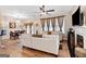 Bright living room with fireplace, hardwood floors, and view into the dining area at 988 Treymont Way, Lawrenceville, GA 30045