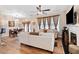 Cozy living room with hardwood floors, fireplace, modern ceiling fan, and comfortable seating area at 988 Treymont Way, Lawrenceville, GA 30045
