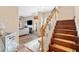 Warm entryway with stairs and a peek into the cozy living room with fireplace and plush seating at 988 Treymont Way, Lawrenceville, GA 30045