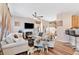 Open-concept living room with hardwood floors, fireplace, modern ceiling fan, and comfortable seating at 988 Treymont Way, Lawrenceville, GA 30045