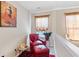 Cozy loft seating area with reading nook, carpet, accent chair and ottoman providing a relaxing retreat at 988 Treymont Way, Lawrenceville, GA 30045