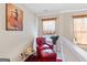 Cozy nook with a red chair, ottoman and decorative artwork at 988 Treymont Way, Lawrenceville, GA 30045