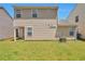 Spacious backyard featuring a lush lawn, an outdoor patio, and beige vinyl siding at 1015 Lakeside Cir, Covington, GA 30016