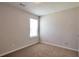 Neutral bedroom featuring plush carpeting, a large window, and ample natural light at 1015 Lakeside Cir, Covington, GA 30016