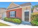Inviting home exterior with a brick facade, a manicured hedge, and an elegant entrance door at 1015 Lakeside Cir, Covington, GA 30016