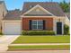 Charming single Gathering home with brick facade, well-manicured lawn, and an attached garage with driveway at 1015 Lakeside Cir, Covington, GA 30016