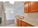 Efficient kitchen design with granite counters, wooden cabinets, and stainless steel appliances at 1015 Lakeside Cir, Covington, GA 30016