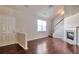 Spacious living room with fireplace, hardwood floors, staircase, and lots of natural light at 1015 Lakeside Cir, Covington, GA 30016