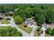 Aerial view of a charming home nestled among lush trees, showcasing its serene and private setting at 130 Lacey Oak Ln, Loganville, GA 30052