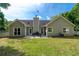 Home featuring a well-maintained backyard, a patio with furniture, and lush green grass at 130 Lacey Oak Ln, Loganville, GA 30052