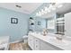 Stylish blue bathroom with double sinks, a large mirror, and ample counter space, providing elegance and functionality at 130 Lacey Oak Ln, Loganville, GA 30052