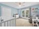Light-filled Bedroom with a crib, changing table, and comfortable seating area at 130 Lacey Oak Ln, Loganville, GA 30052