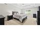Charming bedroom with a ceiling fan, neutral paint, and a window, providing a bright and relaxing atmosphere at 130 Lacey Oak Ln, Loganville, GA 30052