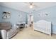 Bright Bedroom complete with crib, chair and wall decor at 130 Lacey Oak Ln, Loganville, GA 30052