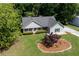 Charming home featuring a manicured lawn, mature trees, and professional landscaping, creating a welcoming curb appeal at 130 Lacey Oak Ln, Loganville, GA 30052
