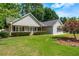Charming single story home with manicured lawn, mature trees, and inviting front porch at 130 Lacey Oak Ln, Loganville, GA 30052