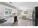 Well-lit kitchen with adjacent breakfast area, stainless steel appliances, and tiled backsplash at 130 Lacey Oak Ln, Loganville, GA 30052