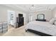 Bright main bedroom with a tv, dresser, storage bins, and ensuite bathroom for added convenience at 130 Lacey Oak Ln, Loganville, GA 30052