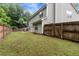 Large, grassy backyard featuring a wood fence, perfect for outdoor activities and privacy at 3265 Watson Gate Rd, Loganville, GA 30052