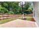 A backyard boasting a well-maintained basketball area and a fenced perimeter for ultimate privacy at 3265 Watson Gate Rd, Loganville, GA 30052