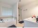 A serene bathroom with a soaking tub and a separate shower at 3265 Watson Gate Rd, Loganville, GA 30052
