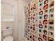 Bathroom featuring a toilet, colorful shower curtain, and bright window with neutral walls and flooring at 3265 Watson Gate Rd, Loganville, GA 30052