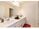 Bathroom showcasing a double sink vanity, framed mirror, and ample storage space with clean white walls at 3265 Watson Gate Rd, Loganville, GA 30052
