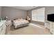 Neutral bedroom with carpet, white trim, a queen sized bed, and a window allowing for natural light at 3265 Watson Gate Rd, Loganville, GA 30052