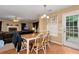 Cozy dining area featuring hardwood flooring, a table with chairs, and a door to the backyard at 3265 Watson Gate Rd, Loganville, GA 30052