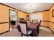 Inviting dining room showcasing a chandelier, large windows, and carpet flooring at 3265 Watson Gate Rd, Loganville, GA 30052