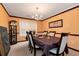Charming dining room featuring a chandelier, large windows, and carpet flooring at 3265 Watson Gate Rd, Loganville, GA 30052