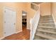 Open foyer with hardwood floors, a staircase with white railings, and a view into the living room at 3265 Watson Gate Rd, Loganville, GA 30052