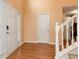 Inviting foyer featuring hardwood floors, a staircase, and natural light streaming through the front door at 3265 Watson Gate Rd, Loganville, GA 30052