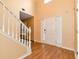 Bright foyer featuring hardwood floors, a white staircase, and a front door with sidelights at 3265 Watson Gate Rd, Loganville, GA 30052