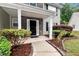 Inviting entryway with manicured landscaping, a walkway, and a front door with stone accents on the two-story home at 3265 Watson Gate Rd, Loganville, GA 30052