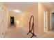 Upstairs hallway with neutral carpet, walls, and trim that features a full length mirror and multiple door entrances at 3265 Watson Gate Rd, Loganville, GA 30052