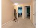 Second floor hallway showcasing neutral carpet and paint, a mirror, and access to multiple rooms at 3265 Watson Gate Rd, Loganville, GA 30052