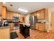 Well-lit kitchen includes stainless steel appliances, wooden cabinets, granite countertops and a moveable center island at 3265 Watson Gate Rd, Loganville, GA 30052