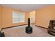 Open-concept living room featuring carpet flooring, orange walls, and a window at 3265 Watson Gate Rd, Loganville, GA 30052