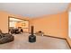 Spacious living room with carpet flooring, orange walls, and dining area access at 3265 Watson Gate Rd, Loganville, GA 30052