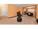 Open living room featuring orange walls, carpet flooring, and dining room access at 3265 Watson Gate Rd, Loganville, GA 30052